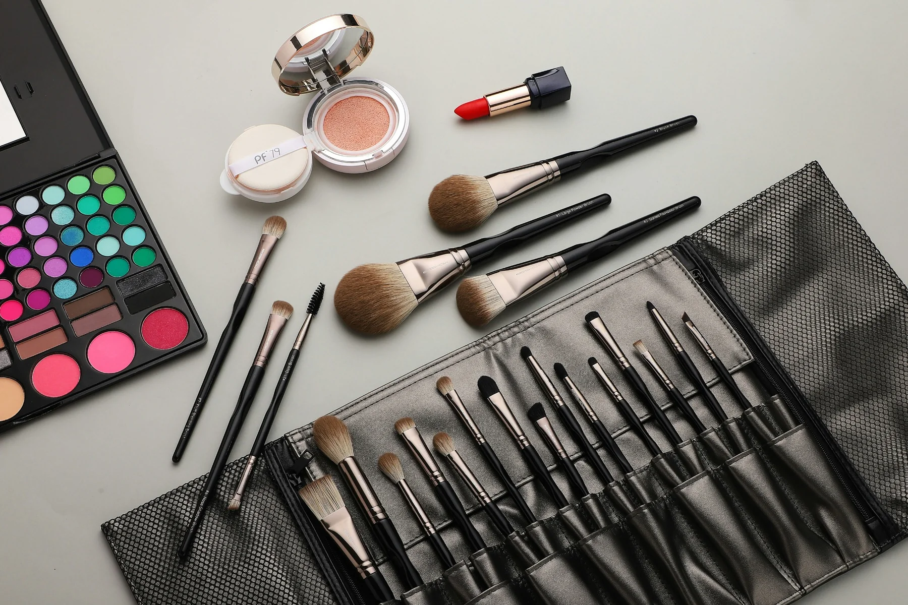 Professional makeup kit and cosmetics arranged for artistry